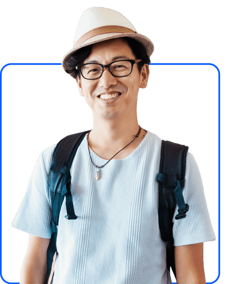 Smiling man in glasses wearing a red checkered shirt over a gray T-shirt, against a white background.