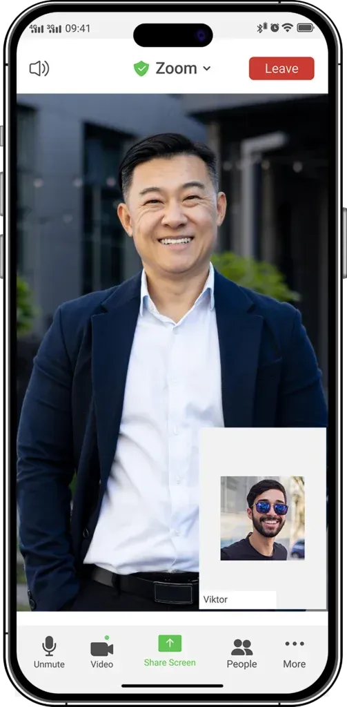 Phone screen showing a smiling man in a navy blazer during a video call, with call controls visible.